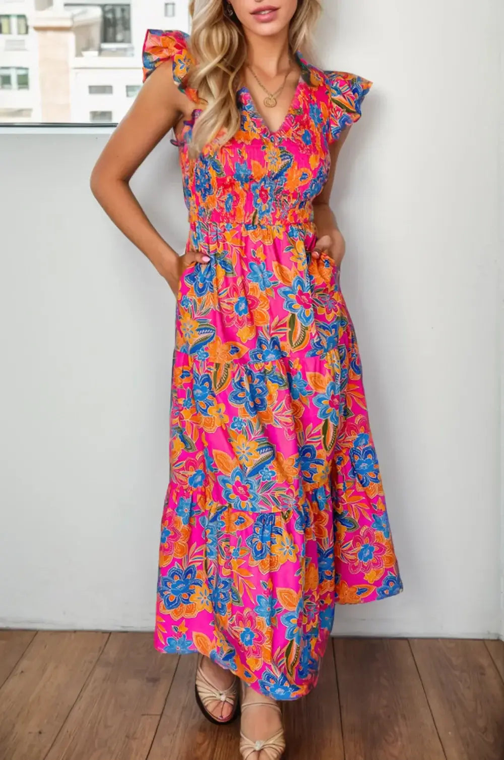 Printed V-Neck Cap Sleeve Pocketed Midi Dress worn by a model, featuring vibrant floral patterns and pockets.